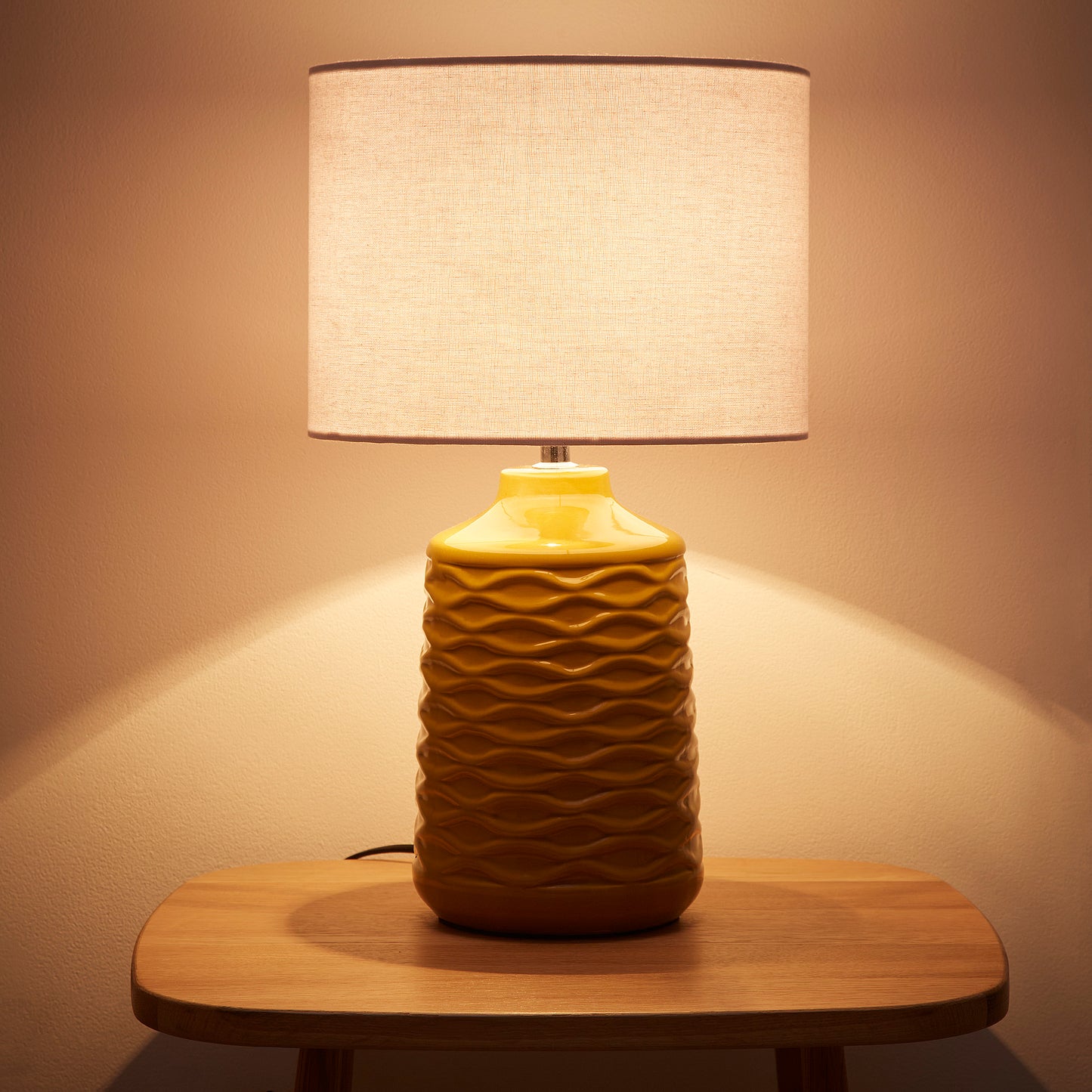 Ivy Ceramic Table Lamp With White Linen Shade and a wave design textured base