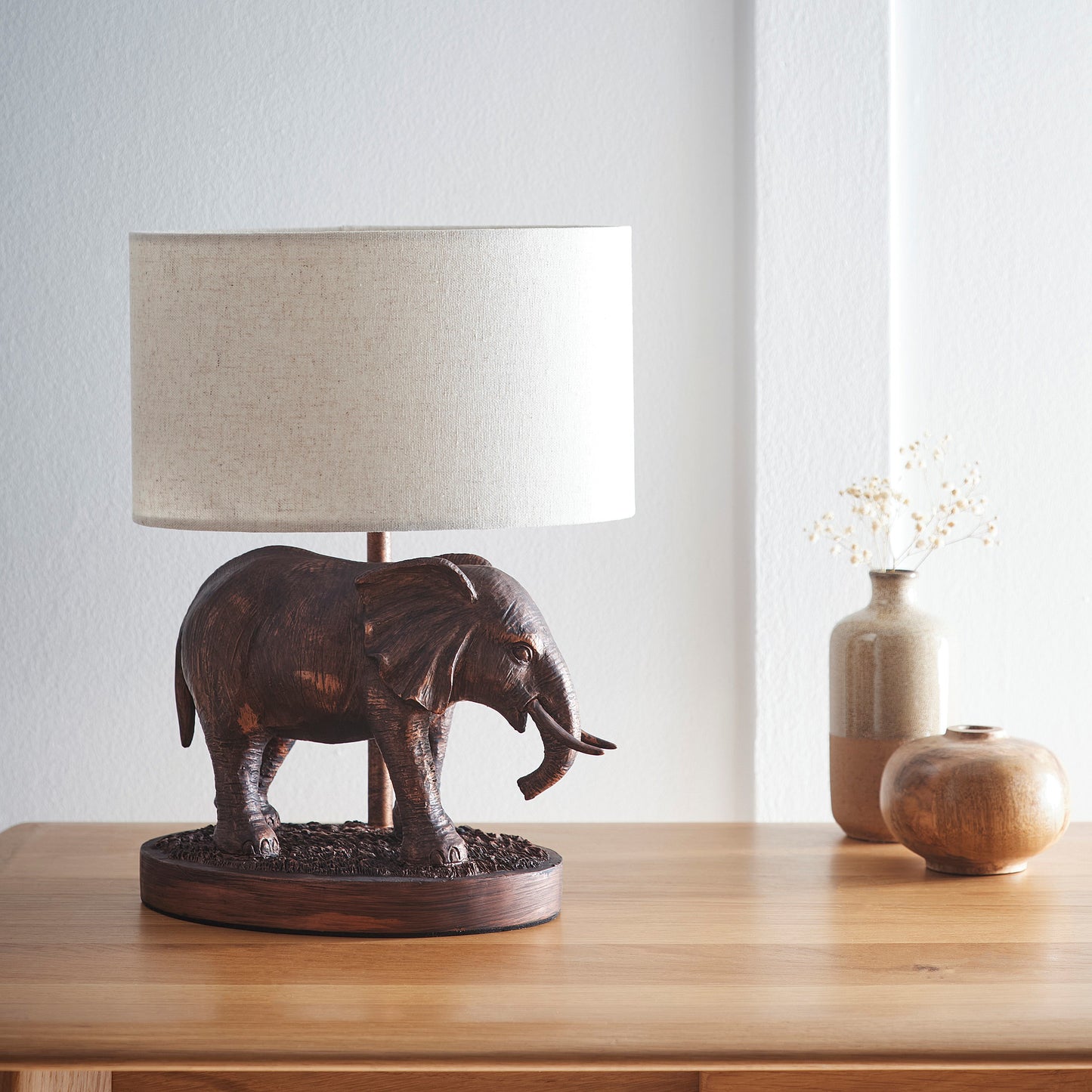 Elephant Lamp in an Antique Copper Resin Table Lamp with an Oval Natural Linen Shade
