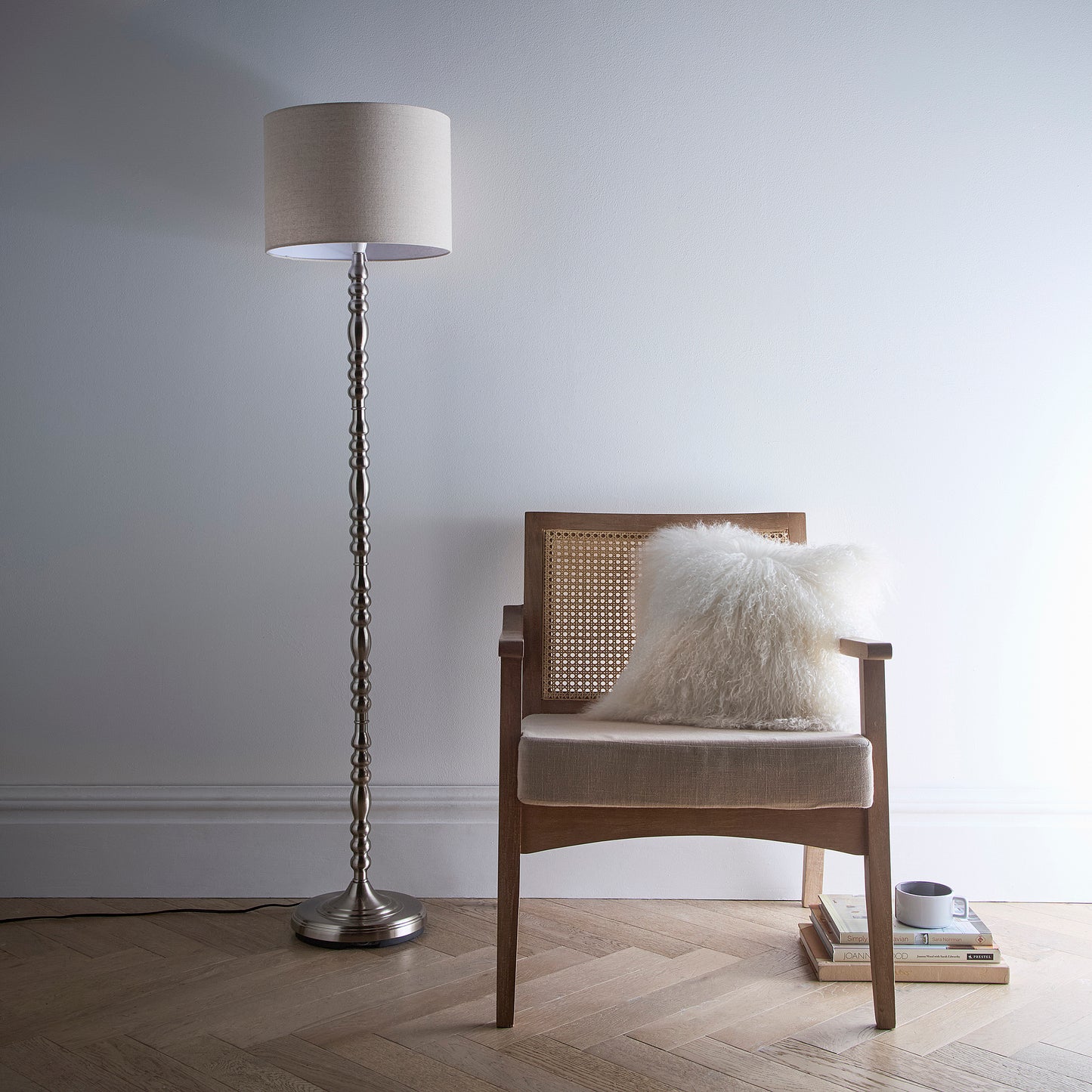 Floor Lamp in a Ribbed Satin Nickel finish on a tall candlestick design base with a Natural Linen Lampshade